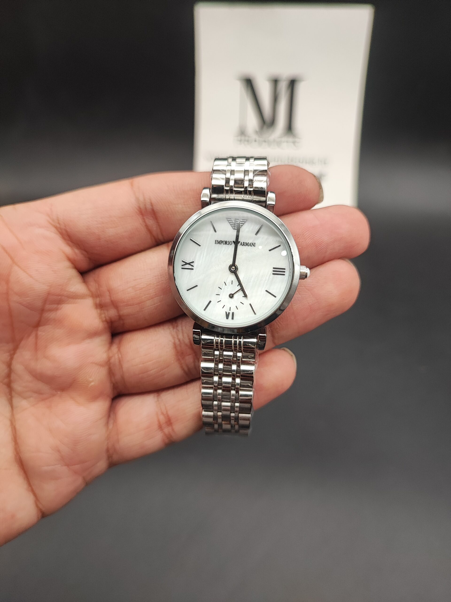 Emporio Armani women's watch with white dial, stainless steel bracelet, and elegant minimalist design