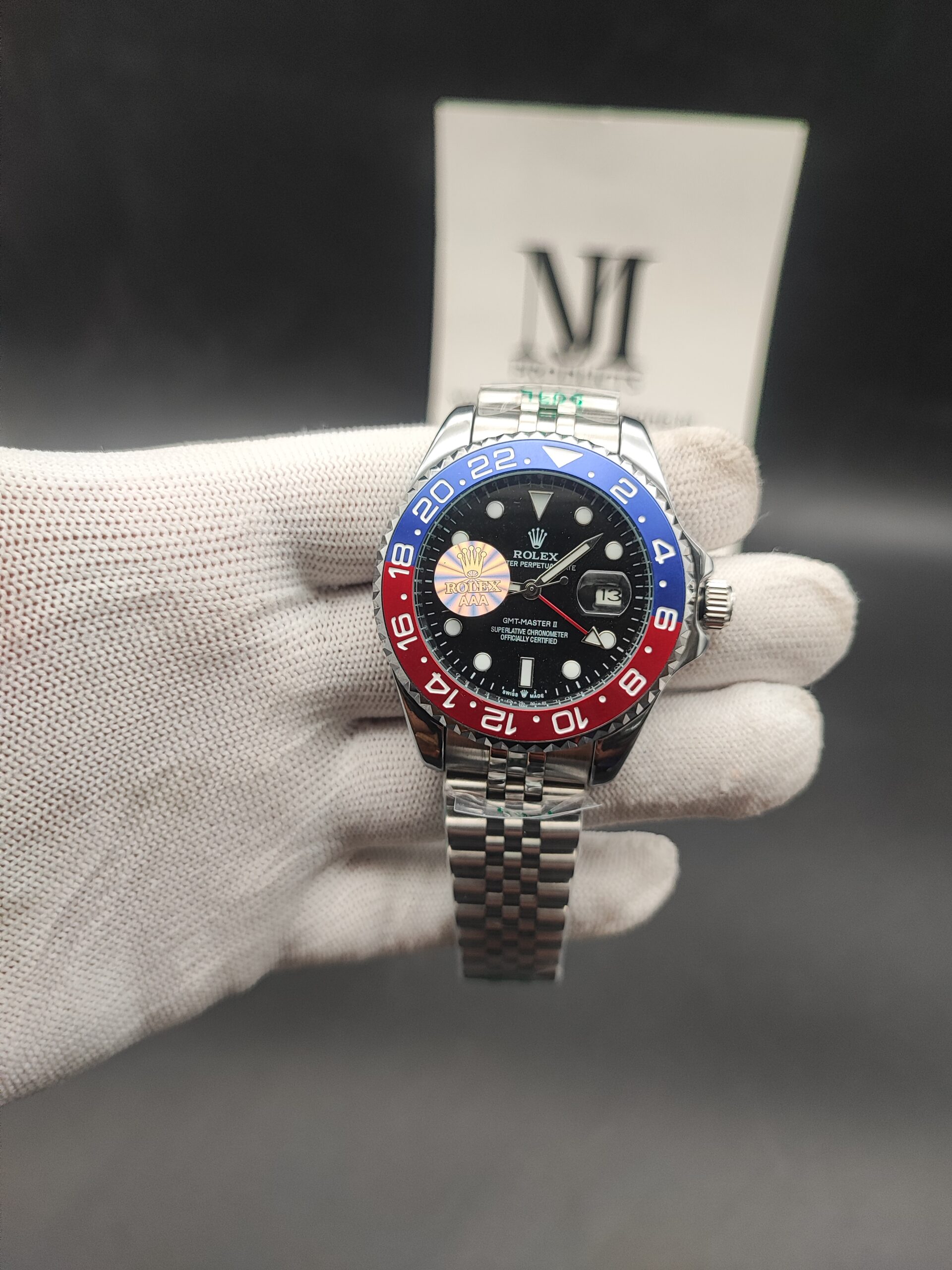 Rolex GMT-Master II watch with black dial, red and blue Pepsi bezel, date display, and stainless steel bracelet